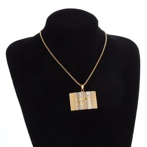 Golden Holy Bible pendant necklace with rhinestones and cross on a black mannequin