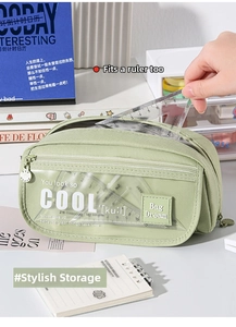 Detail of light green canvas pencil case with dual zippers and clear front PVC pocket