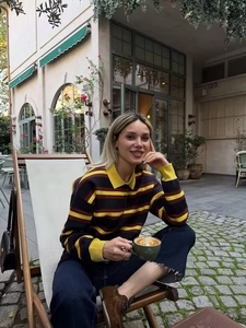 Detail of a striped knit polo sweater with yellow and brown bands for casual autumn wear