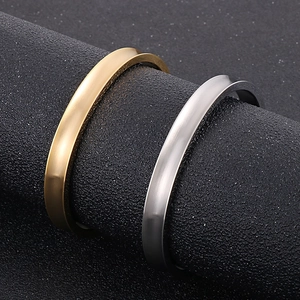 Detailed view of matte brushed stainless steel cuff bracelets in gold and silver finish