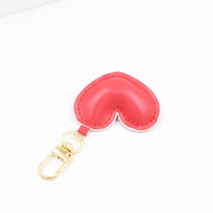 Detail of red PU leather heart keychain with premium gold metal ring and lobster clasp
