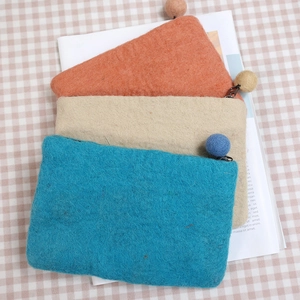 Handmade wool felt dandelion coin purse set in blue, beige, and orange with decorative balls
