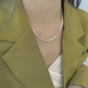 Close-up of 925 sterling silver pig nose chain necklace worn on a fashion model