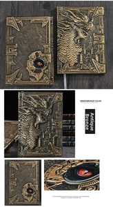 Close-up of Green Bronze A5 notebook with 3D embossed dragon and castle texture