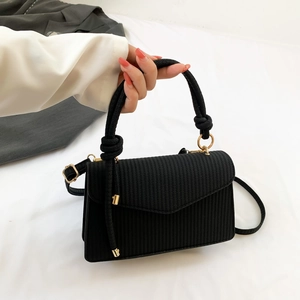 Chic black textured crossbody square bag with knotted rope handle and gold accents