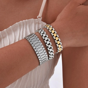 Wrist view of stainless steel watch band bracelets in silver and dual-tone gold colors