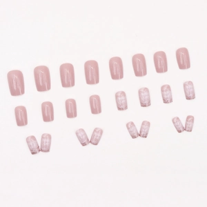 Pink press-on nail kit with 24 pieces featuring glitter ombre and hollow French design