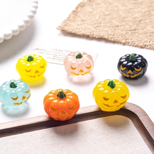 Close-up of colorful resin Halloween pumpkins for miniature decor and DIY crafts