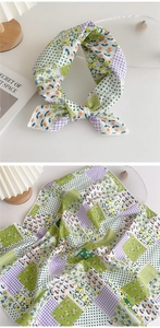 Detail of a patchwork neckerchief featuring floral, polka dot, and grid patterns