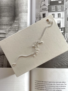 Detailed view of a 925 sterling silver beaded bracelet with heart charm and spring clasp