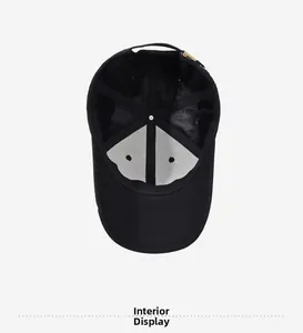 Interior view of black baseball cap showing cotton twill fabric and adjustable metal buckle