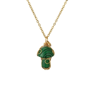 Detail of green malachite mushroom pendant with handcrafted gold wire wrapping