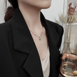 Detail of silver heart pendant necklace with bead chain on a professional model