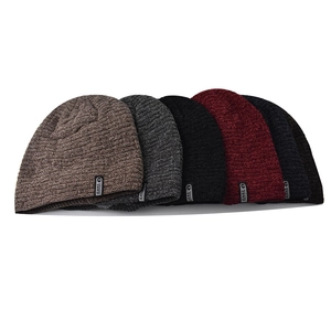 Detailed knit texture of winter beanies in five colors with decorative cloth labels