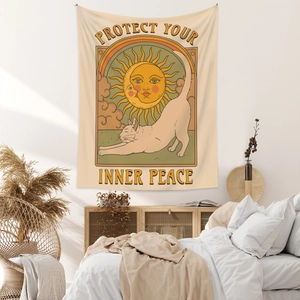 Bohemian cat tapestry with Sun and Moon design and Protect Your Inner Peace text in a cozy room