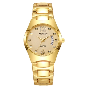 Detail of gold quartz watch dial with crystal indices and fan-shaped date display window