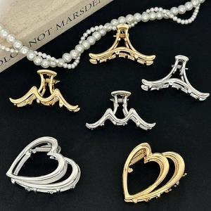 Minimalist gold and silver large metal hair claws in heart and geometric shapes