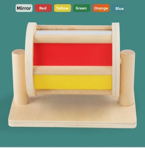 Close-up of Montessori wooden spinning drum with colorful panels and integrated mirror