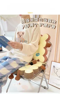 Detail view of thickened biscuit chair cushion with plaid edges and cartoon embroidery