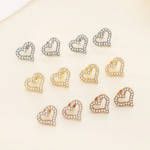 Detailed view of heart-shaped hollow earrings in silver, gold, and rose gold with pavé zircons