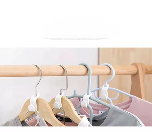 Space-saving white S-shaped plastic hanger connector hooks for vertical closet storage