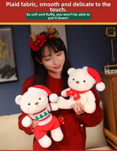 Close-up of cute Christmas teddy bears in red tree sweater and scarf being held by a model