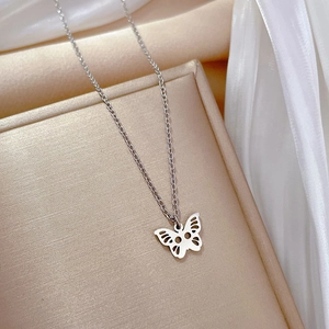 Detailed close-up of a silver hollow butterfly pendant on a delicate link chain necklace