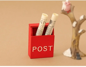 Miniature red wooden mailbox with POST text and tiny scrolls for dollhouse decoration