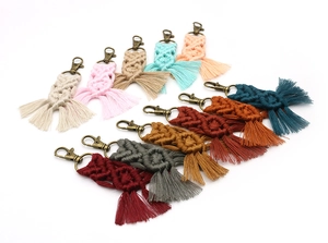 Detailed view of ten colorful handmade braided cotton rope keychains with vintage metal clasps