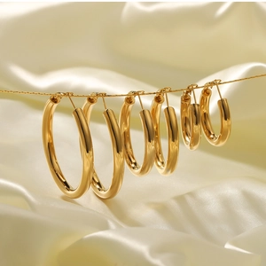 Detailed set of four pairs of 18K gold plated hollow hoop earrings in varying sizes