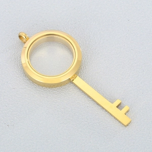 Detailed view of a gold stainless steel key-shaped locket with a clear glass window