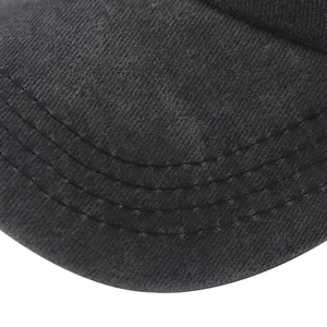 Macro view of black washed cotton baseball cap brim with detailed triple-row stitching