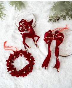 Détails d'ornements de Noël floqués bordeaux avec paillettes dorées sur fond de neige