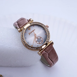 Close-up of a rose gold watch featuring a diamond-set bezel and a brown leather crocodile strap