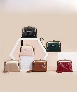 Kiss-lock coin purses in six colors displayed on minimalist stands with wrist straps