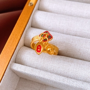 Detailed view of gold Chinese lucky ring with flower and gold ingot motifs in a gift box