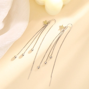 Elegant silver star tassel drop earrings with long fringe chains on aesthetic background