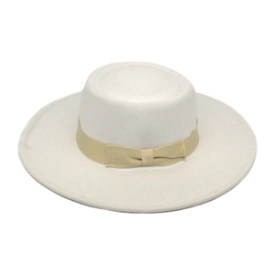 Detail of white wool fedora hat featuring a beige satin ribbon and a flat bow accent