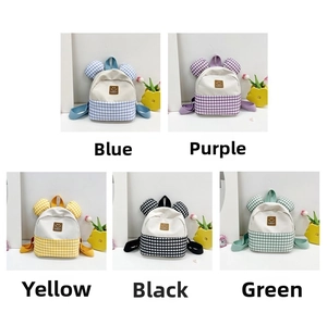 Detail view of colorful checkered toddler backpacks with cartoon ears in five colors