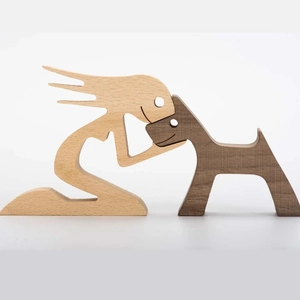 Minimalist wooden sculpture of a person and dog interacting in natural timber