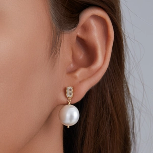 French vintage s925 silver pearl drop earrings with rectangular zircon on a female model