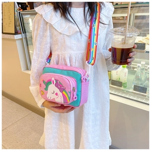 Detailed view of unicorn shoulder bag with dual zippers and colorful rainbow strap