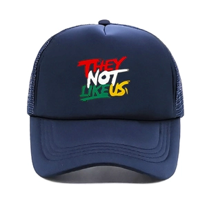 Detail of navy blue mesh trucker hat featuring colorful They Not Like Us graffiti print