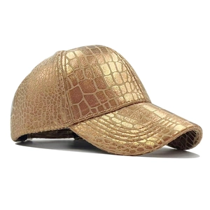 Golden baseball cap with metallic crocodile pattern texture on a white background