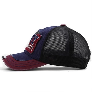 Detail of vintage navy blue trucker hat with NY embroidery and distressed mesh