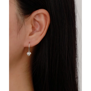 Close-up of s925 silver heart-shaped hoop earring with diamonds on a model's ear