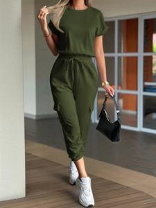 Detail of dark green two-piece lounge set with short sleeve top and drawstring joggers