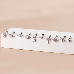 Detailed view of silver surgical steel cartilage studs featuring zirconia hearts and stars