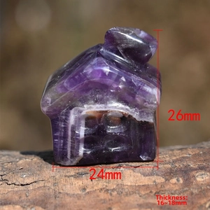Macro shot of natural amethyst house carving with size dimensions on wood background