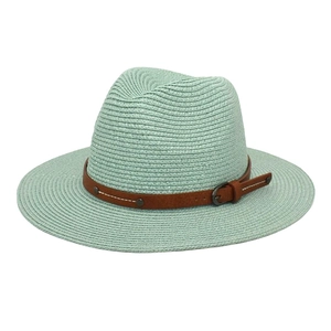 Detail of mint green panama straw hat featuring a brown leather decorative band